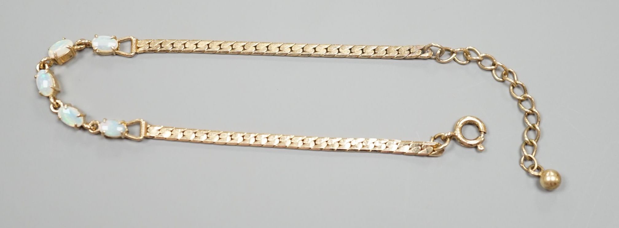 A modern gilt metal and five stone oval white opal set bracelet, 16.5cm.